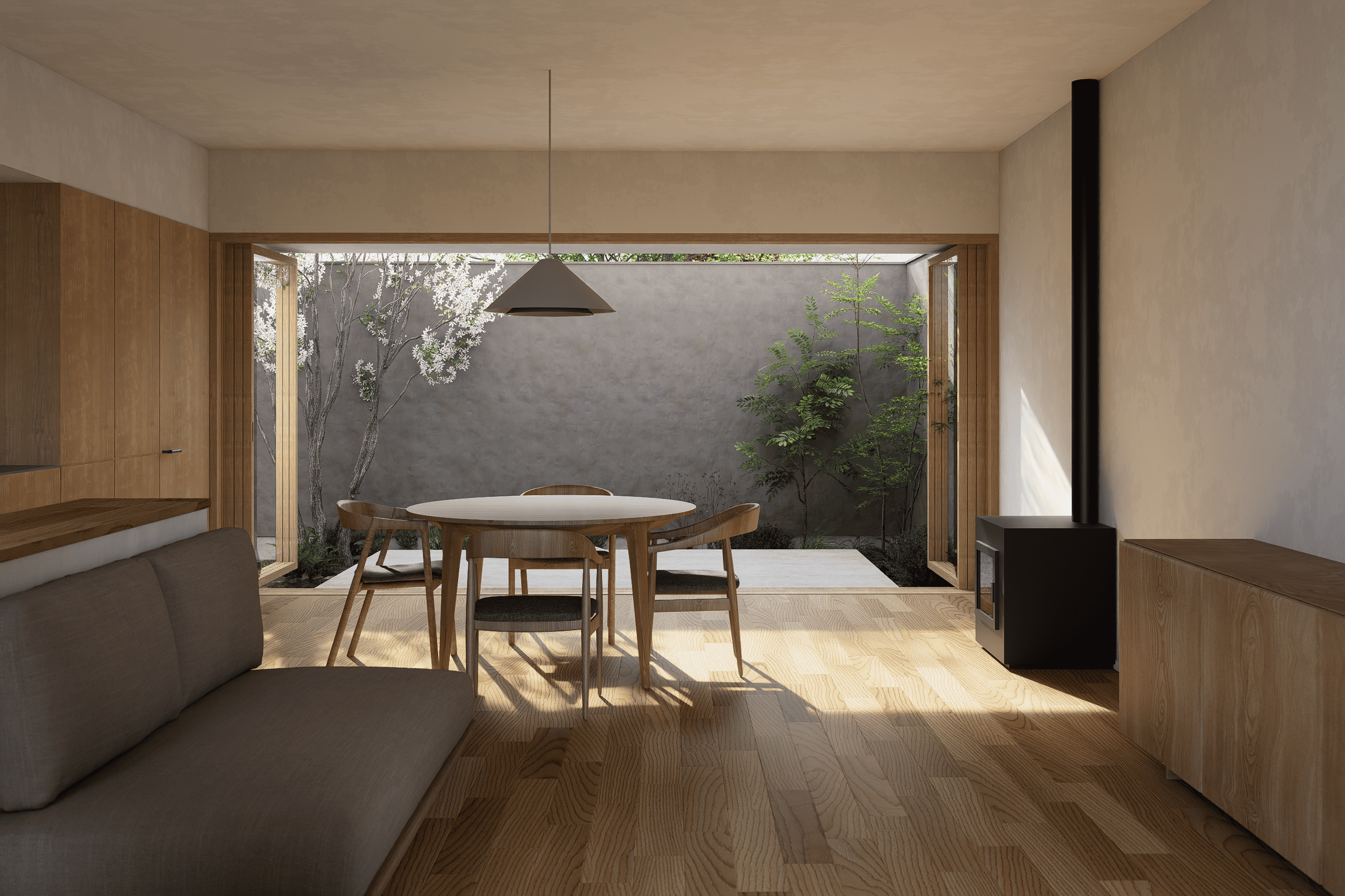 Interior de una vivienda acogedora donde la luz, los materiales naturales y la aperturas hacia el patio crean una relación directa con la naturaleza.